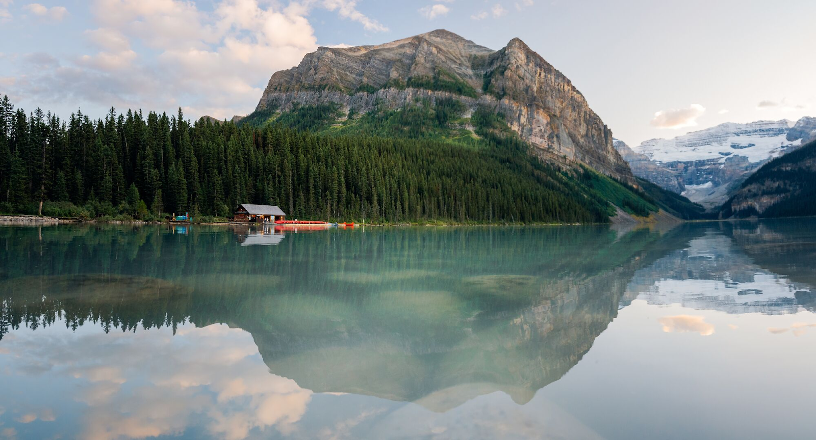 A stunning view of a turquoise lake in Banff National Park with mountains in the background.